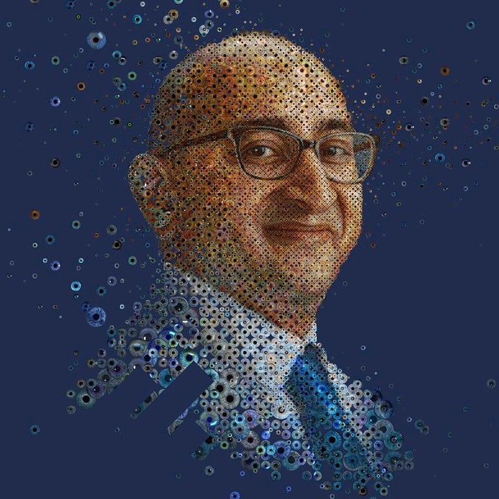 Digitally enhanced portrait of a man with glasses and a tie, made from many small circles on a dark blue background.